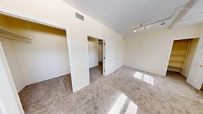 Evanston apartment for rent - A spacious room with carpeted floor and white walls.