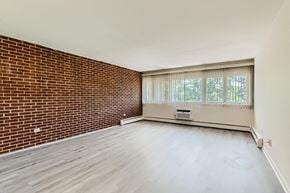 Palatine apartment for rent - an empty living room with a brick wall and a window
