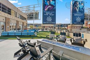 Glendale apartment for rent - A large outdoor seating area with a pool and two large banners advertising the Desert Diamond Casino.