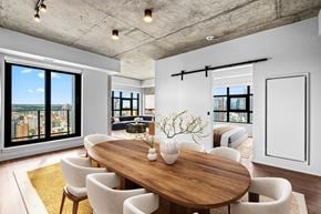 Calgary apartment for rent - Suite 2502 - A modern dining room with a wooden table and chairs.