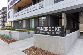 Calgary apartment for rent - A Lynnbrooke building with a sign that says "Now Leasing" and a phone number.