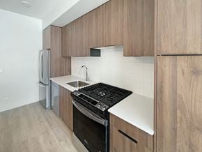 Calgary apartment for rent - a kitchen with wooden cabinets and a stove and a sink
