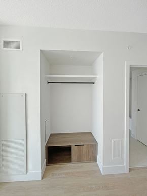 Calgary apartment for rent - an empty hallway with a closet and a staircase in a house