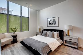 Edmonton apartment for rent - bedroom with a large bed in a room with large windows  at Citizen on Jasper, Edmonton, Alberta