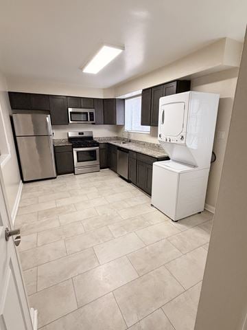 Alexandria townhouse for rent - A kitchen with a white refrigerator, black cabinets, and a tiled floor.