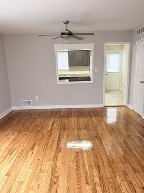 Alexandria townhouse for rent - A room with a ceiling fan and a window.