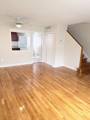 Alexandria townhouse for rent - A room with wooden flooring and a staircase.
