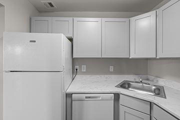 Kensington apartment for rent - A white refrigerator is in a kitchen with a white counter top.