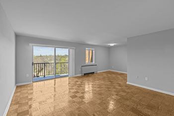 A room with wooden flooring and a balcony