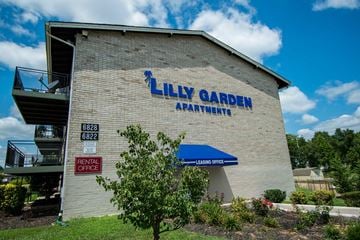 Lanham apartment for rent - the side of a building with a sign for lily garden apartments
