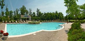 Midlothian apartment for rent - A large swimming pool surrounded by a patio and trees.