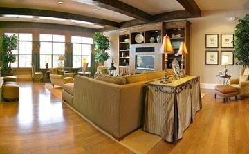 Midlothian apartment for rent - A living room with a long couch and a table with a lamp on it.