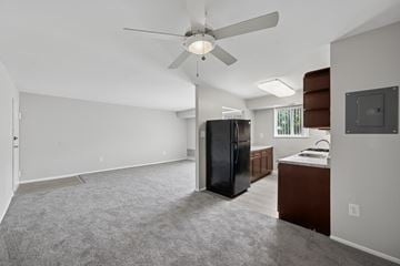 Capitol Heights apartment for rent - A spacious kitchen with a black refrigerator and a ceiling fan.
