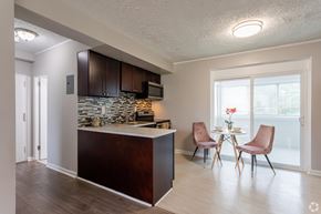 Greenbelt apartment for rent - A kitchen with brown cabinets and a white countertop.