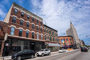 Chicago apartment for rent - A street view of a city with cars and buildings.