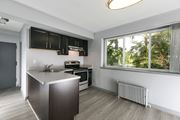 Greenbelt apartment for rent - A modern kitchen with a stainless steel island and wooden flooring at Crescent Pointe Apartments, Greenbelt, Maryland