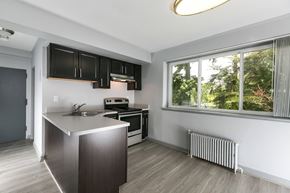 Greenbelt apartment for rent - A modern kitchen with a stainless steel island and wooden flooring at Crescent Pointe Apartments, Greenbelt, Maryland