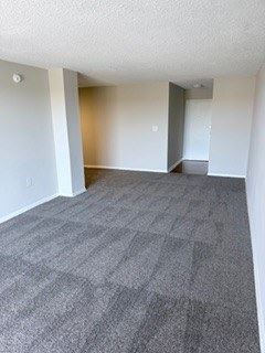 Laurel apartment for rent - A family room with a carpeted floor and white walls.