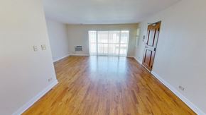 Riverdale apartment for rent - an empty living room with wood flooring and a window