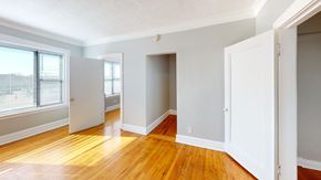 Chicago apartment for rent - A room with wooden floors and white walls.