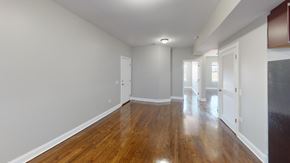 Chicago apartment for rent - A room with wooden floors and white walls.