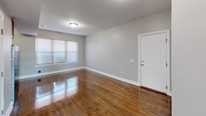 Chicago apartment for rent - A room with a white door and a window with white blinds.