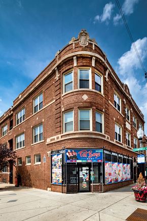 Chicago apartment for rent - a brick building with a store on the corner of a street
