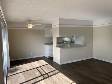 Salinas apartment for rent - an empty living room with a kitchen and a ceiling fan