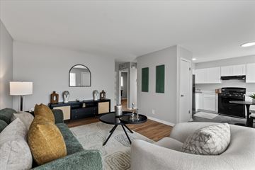 Ypsilanti apartment for rent - A living room with a grey couch and a black coffee table.