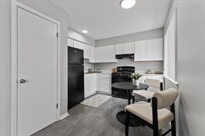 Ypsilanti apartment for rent - A black and white photo of a kitchen with a table and chairs.