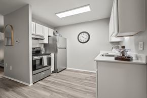 Riverview apartment for rent - A modern kitchen with a stainless steel refrigerator and a wooden floor.