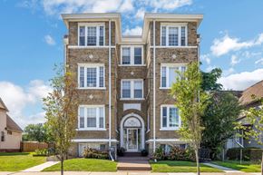 Detroit apartment for rent - the front of a brick house with trees in front of it