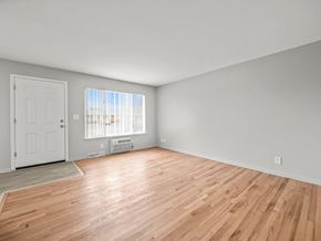 Ypsilanti apartment for rent - a bedroom with hardwood floors and grey walls