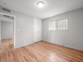Ypsilanti apartment for rent - a bedroom with hardwood floors and grey walls