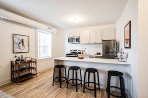 Detroit apartment for rent - A kitchen with white cabinets and a white counter top.