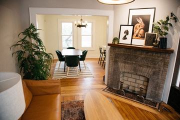 Detroit apartment for rent - a living room with a fireplace and a table and chairs
