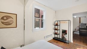 Detroit apartment for rent - a bedroom with a white bed and a window