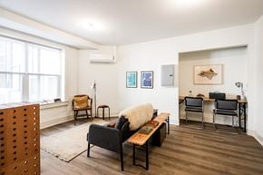 Detroit apartment for rent - A living room with a couch, chairs, and pictures on the wall.
