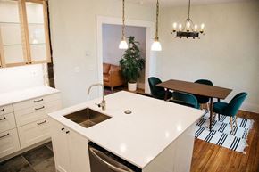 Detroit apartment for rent - a white kitchen with a sink and a table