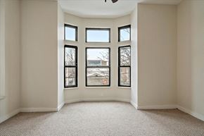 Detroit apartment for rent - an empty room with four windows and a ceiling fan