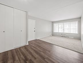 Ypsilanti apartment for rent - a bedroom with hardwood floors and white walls