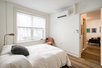 Detroit apartment for rent - A bedroom with a large bed and a window.