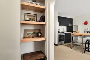 Detroit apartment for rent - A kitchen with a table and a framed picture on the shelf.