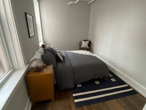 Detroit apartment for rent - a bedroom with a bed and a window