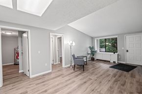 Monroe apartment for rent - A room with a wooden floor and a window with a view of trees.