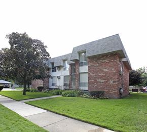 Ferndale apartment for rent - A brick house with a white building behind it.