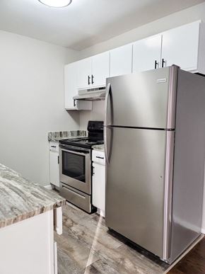 Ferndale apartment for rent - A kitchen with a refrigerator, oven, and microwave.
