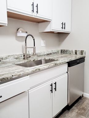 Ferndale apartment for rent - A kitchen with a marble countertop and white cabinets.
