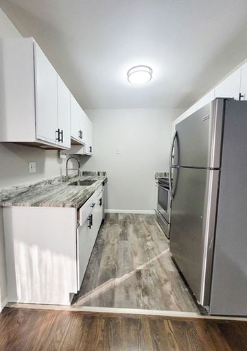 Ferndale apartment for rent - a kitchen with stainless steel appliances and white cabinets