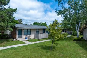 Sterling Heights apartment for rent - a home with a porch and a tree in front of it